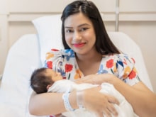 closeup portrait of young asian indian hispanic mother day holding newborn baby with copy space. healthcare and medical daycare nursery love lifestyle together single mom motherâs day holiday concept