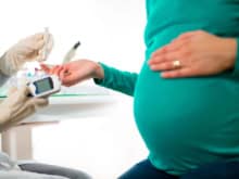 pregnant woman having blood glucose checked