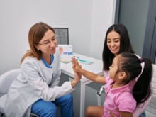 friendly pediatrician meeting with asian mother and child in hospital. consultation, kid health